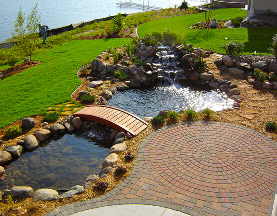 cobble stone pavers next to a small pond